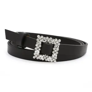 Close up of black PU leather skinny belt with sparkling rhinestone crystal square buckle detail