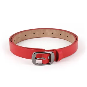 Close-up view of a red women's leather belt with a sleek silver metal pin buckle.