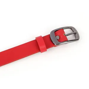 Close-up detail of red leather belt with dark metal buckle, clean minimalist design.
