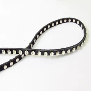 Detailed view of women's black leather thin rhinestone belt featuring sparkling stud accents.