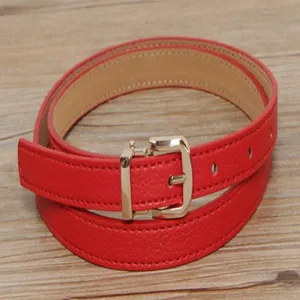 Red leather belt for women with a gold-tone pin buckle, stylish and minimalist accessory.