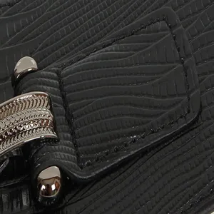 Detailed view of women's black textured wide belt buckle showing fine craftsmanship and style.