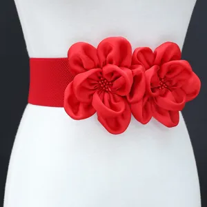 Wide red elastic waist belt with large chiffon flower decorations, stylish dress cincher.