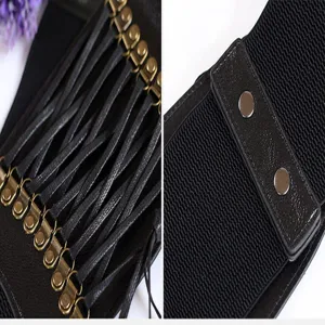 Close-up detail of black wide elastic corset waist belt with bronze metal rings and leather fringe.