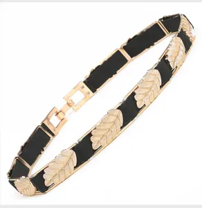 Detailed view of the elegant gold leaf elastic waist belt, perfect for dressing up dresses.
