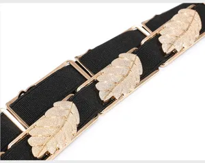 Close-up product detail showing the gold metal leaf buckle on women black elastic waist belt.