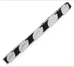Close-up detail of women's black elastic belt featuring elegant silver metal leaf decorations.