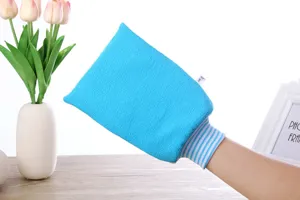 Detailed view of the blue exfoliating bath glove showing textured fabric and elastic wrist.