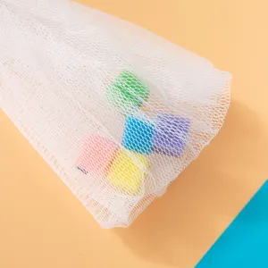 Detail shot showing the white mesh foaming net with colorful sponge cubes inside for rich lather.