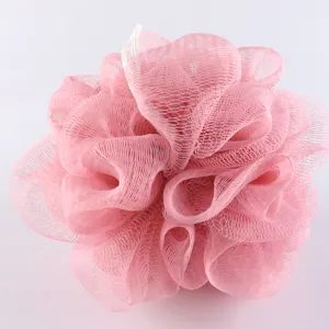 Pink mesh shower puff bath sponge with hanging string for body cleaning and gentle exfoliation.