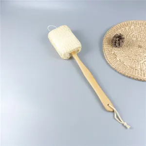 Close-up detail of the natural sisal bath brush with long wooden handle and mesh exfoliating head.