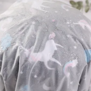 Detailed view of waterproof PVC shower cap with cute unicorn and rainbow print pattern.