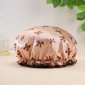 Waterproof double-layer satin shower cap with cute bow print and ruffled brown trim.