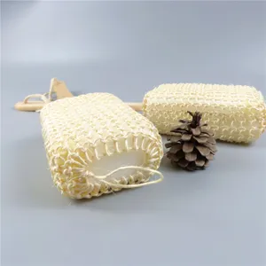 Close-up detail of natural sisal fiber bath sponge with wooden handle for gentle body exfoliation.