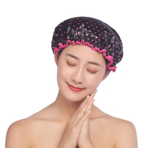 Wasserdichte Duschhaube mit rosa Punkten und elastischem Rand für die Haarpflege zu Hause.