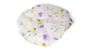 Waterproof floral shower cap detail showing the purple flower pattern and fabric texture.
