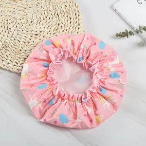 Pink cartoon print waterproof double layer shower cap with elastic lace for home bathroom use.