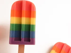 Regenboog ijsjesspons doucheborstel met houten handvat voor lichaamsreiniging en peeling.