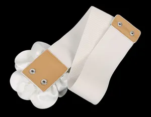Detail shot of the white wide elastic waist belt with a large fabric flower and snap buttons.