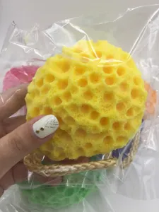 Honeycomb wood pulp bath sponge detail showing soft texture and rope for daily use.