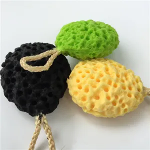 Honeycomb wood pulp facial cleansing sponge detail view showing texture and hanging rope.