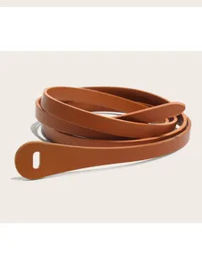 Close-up detail of the brown faux leather thin belt showing texture and loop design.