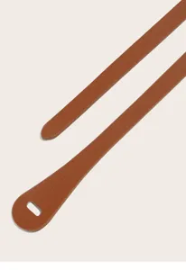 Close-up detail of a slim brown faux leather belt strap, showcasing texture and finish.