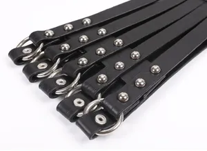 Close-up detail of a black wide waist belt featuring metal rivets and round ring hardware.