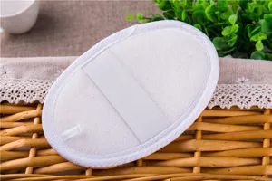 Close-up detail of natural loofah bath sponge with elastic hand strap for gentle skin care.