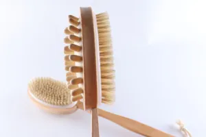 Wooden double-sided massage bath brush detail view, featuring natural bristles and handle.