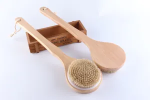 Detailed view of natural wooden long-handled bath brush and back scrubber for skin care.