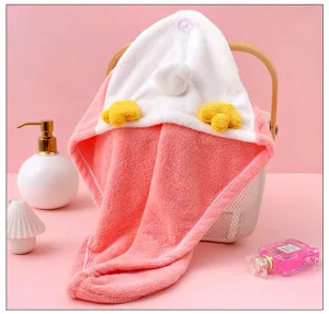 Detailed view of the cute pink coral fleece dry hair cap with adorable cartoon animal feet.