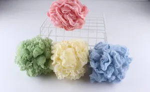 Close-up details of soft lace-trimmed bath sponge mesh puffs in multi colors for body wash.