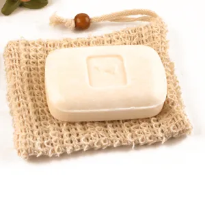 Natural ramie foaming net bag with a solid soap bar, perfect for daily bath and body care routine.