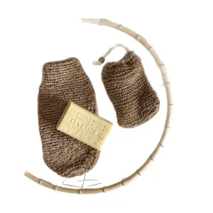 Natural jute soap bag and exfoliating pouch set with botanical soap bar, minimalist style.