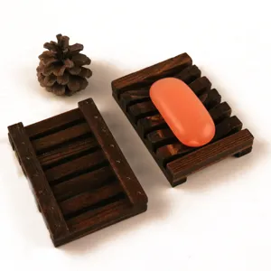 Wooden soap dish set detail showing natural wood grain texture and draining slotted design.