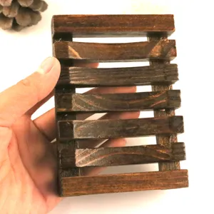 Wooden soap holder detail view showcasing slatted drainage design and natural wood texture.