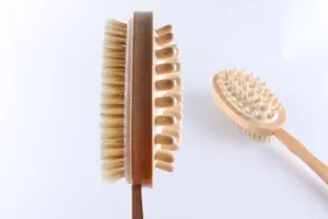 Wooden double-sided bath brush with natural bristles and massage nubs for cleaning.