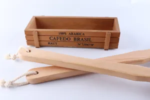 Long wooden handle bath brush for body back cleaning with hanging rope and rustic box prop