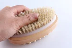Wooden bath brush detail showing natural bristles and ergonomic handle for daily body massage.