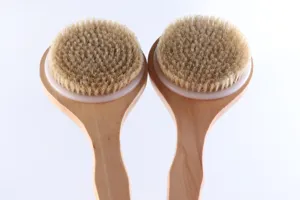 Close-up detail of long handle wooden body bath brushes with natural bristles for clean.