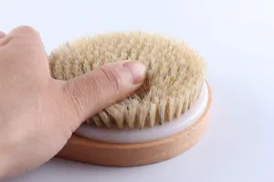 Round wooden body dry brush with natural bristles, perfect for skin exfoliation and daily bath.