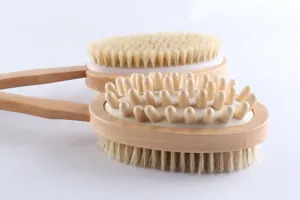 Close-up detail of wooden double-sided bath brush with natural bristles and massage nodes.