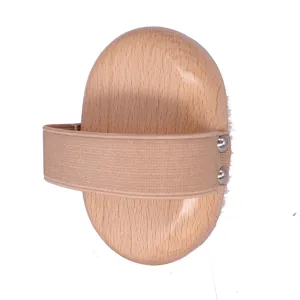 Wooden massage brush detail, ergonomic oval shape with elastic band and metal rivets for easy grip.