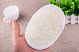Close-up view of large natural loofah bath sponge showcasing plant fiber texture details.