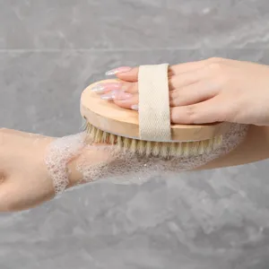 Wooden bath brush with soft bristles and hand strap for gentle body cleansing and shower care.