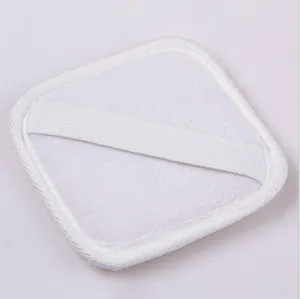 Detail shot of the white loofah bath sponge surface and elastic hand strap for daily use.