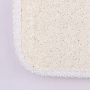 Natural loofah bath scrubber pad with white fabric trim for deep cleansing and exfoliating care.