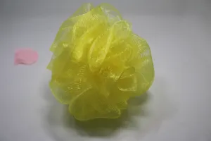 Detailed view of bright yellow mesh bath sponge shower puff for body scrubbing and foaming daily.