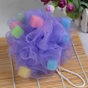 Large purple mesh bath sponge with colorful small sponges and hanging rope for daily shower use.